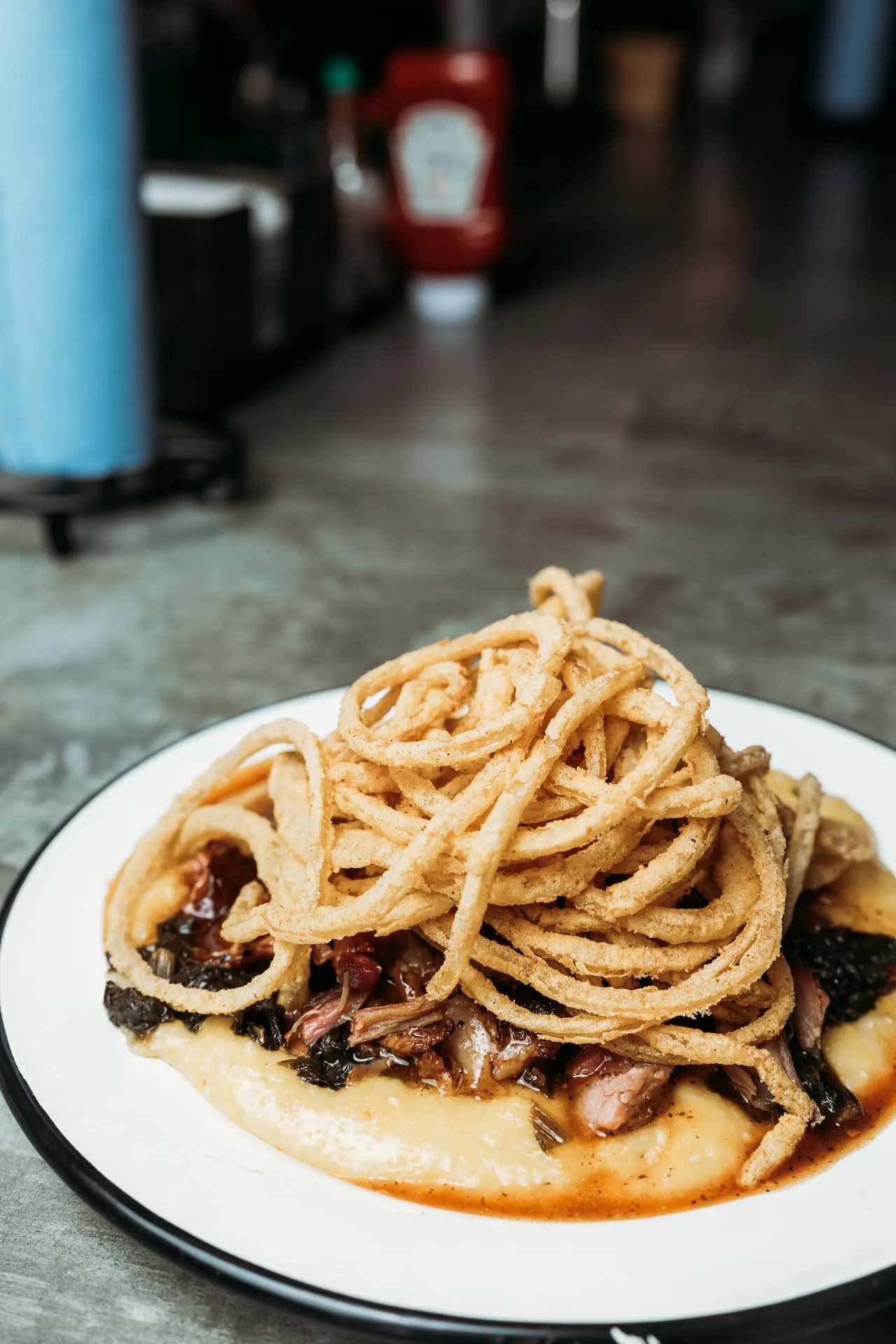 SAW's pork and greens with crispy onion strings